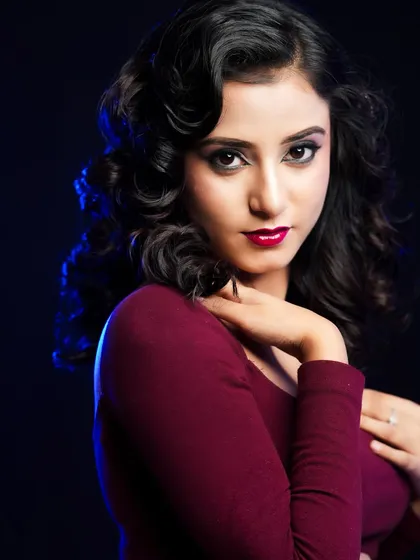 A confident and alluring pose, showcasing the timeless beauty of the red lip and winged liner combination.