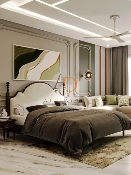 This bedroom combines classic elegance with modern comfort, featuring ornate wall paneling, a large abstract art piece, and a cozy seating area.