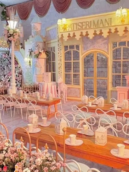 The entire venue transformed into a dreamy, pastel-colored Parisian street.