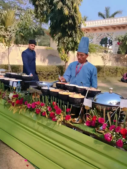 A wide view of our outdoor buffet service, with a chef attending to guests and maintaining the presentation of the food throughout the event.