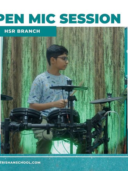 A photo of a student playing the drums at our HSR branch open mic session.