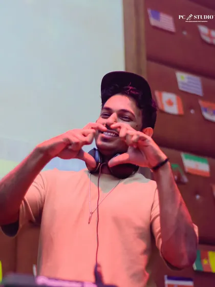 Showing some love to the crowd with a heart sign. I'm genuinely grateful for everyone who comes out to support my music.