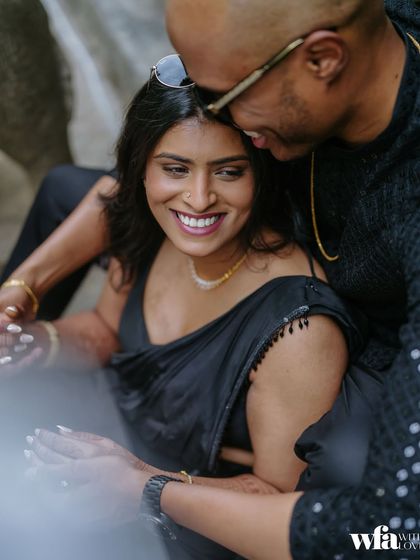 A close-up, intimate portrait that focuses entirely on the couple's connection and happiness, with the venue's greenery softly blurring in the background.