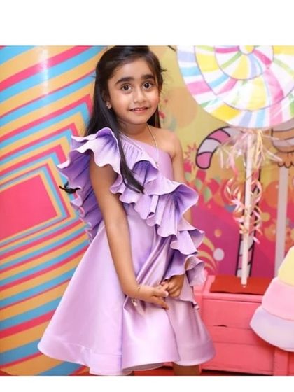 Our "Desire" dress in a lovely shade of lilac purple, seen here at a Candyland-themed party. The color is soft yet eye-catching, perfect for a fun celebration.