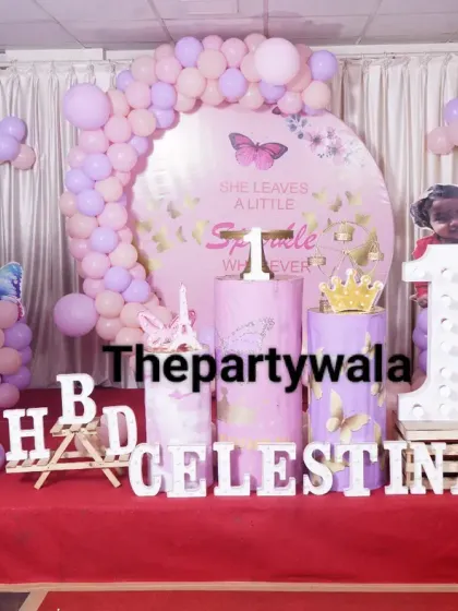 A beautiful fairy and butterfly theme with a "She leaves a little sparkle" backdrop. The setup includes a large fairy cutout and is perfect for a first birthday.