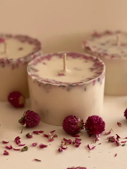 I love incorporating natural elements into my work. These are my artisanal votive candles, made with soy wax and infused with real dried rose petals. They not only smell wonderful but also add a touch of botanical beauty to your space.