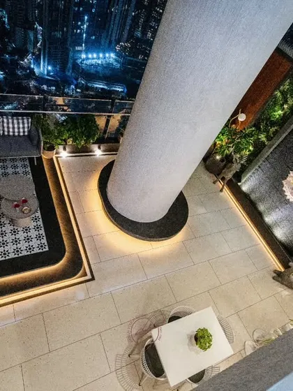 We love transforming outdoor areas into serene escapes. This rooftop terrace features a tranquil Buddha water wall set against a vertical garden, a cozy lounge area, and an open-air dining space, all with a stunning city view. It’s your private retreat in the sky.