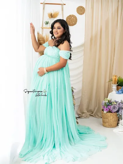 A beautiful window-lit portrait in the mint gown, creating a soft and dreamy effect.