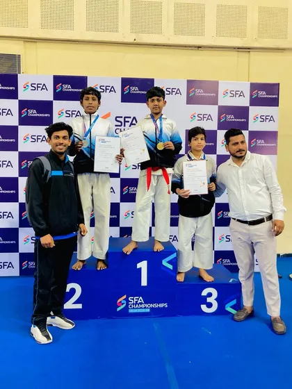 Another angle of my three champions dominating the U-13 podium. Their performance shows the depth of talent we are building in our karate academy.