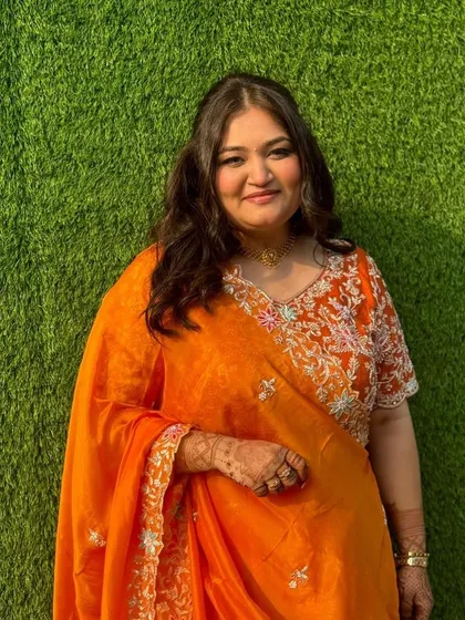 This portrait shows the subtle makeup and hair in natural light. The look is designed to be elegant and understated, perfect for daytime wedding functions.