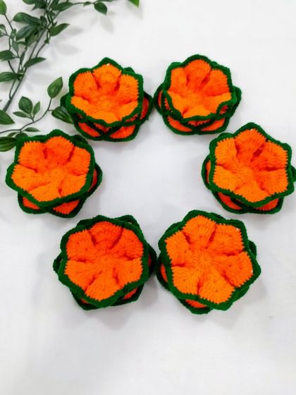A circle of six orange lotus aasans. This shows how they can be arranged for a larger decorative effect or used as a set.