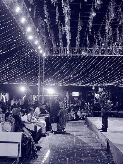 A wide shot of me addressing the audience at a Sangeet. Commanding the stage and connecting with a large crowd is a key part of my job as a host.