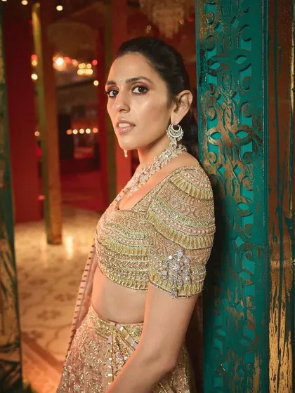 A close-up of the beautifully embroidered blouse of the peach Abu Jani Sandeep Khosla lehenga, showing the delicate craftsmanship.