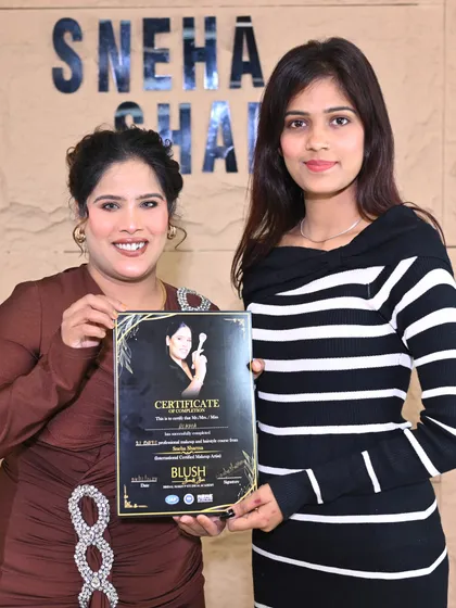 Presenting a certificate to a successful student. This marks the beginning of her professional journey as a makeup artist.