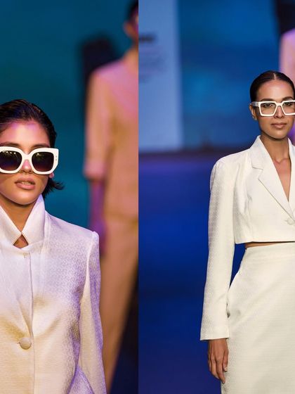 A split-view of two models in modern, tailored white outfits on the runway. This composition highlights the clean lines and contemporary styling of the collection.