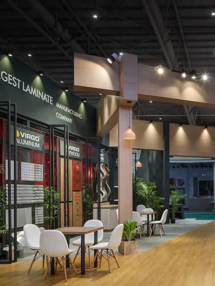 This angle highlights the various product display systems integrated into the Virgo stall's architecture. The design provides a functional and aesthetically pleasing framework for showcasing laminates, aluminum, and plywood.