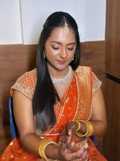 A soft glam look with a traditional touch. The warm, peachy tones on the eyes and cheeks give this bride a beautiful glow for her event.
