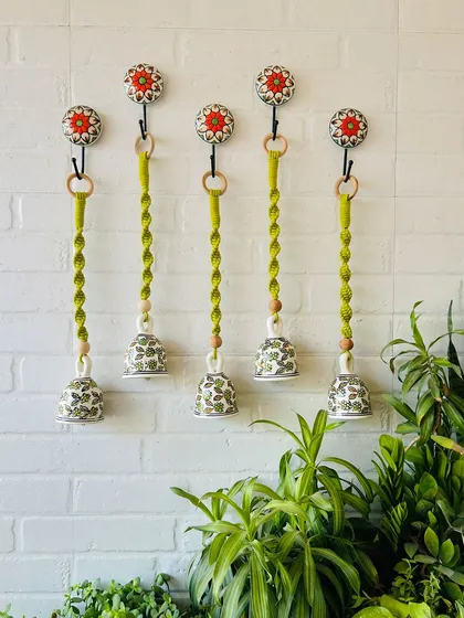 A set of five 'Evergreen' macrame ceramic bells, all in a beautiful green shade. These handcrafted pieces combine the elegance of ceramics with the intricate artistry of macrame, perfect for your garden or balcony.