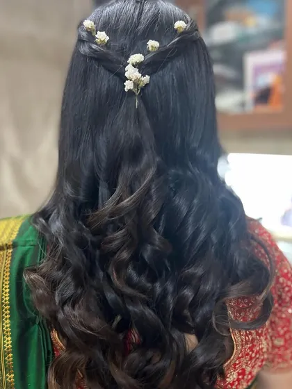 A view of the simple yet elegant hairstyle with fresh flowers, perfect for a baby shower.
