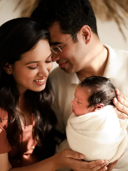 Sweet love. A candid, warm-toned lifestyle shot of a family admiring their new baby. These natural moments are filled with so much emotion.