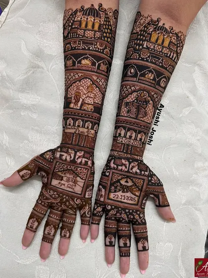 A darker, more contrasted photo of the mother-daughter bond mehendi, showing how the design looks as the henna paste begins to dry.