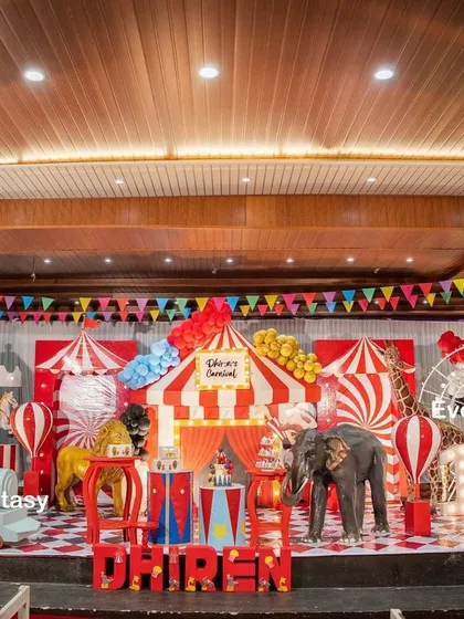 Step right up to Dhiren's grand carnival party. This vibrant indoor stage is filled with classic carnival elements, including a red and white striped big top, a carousel, a Ferris wheel, and friendly animal props, creating an atmosphere of fun and excitement for everyone.