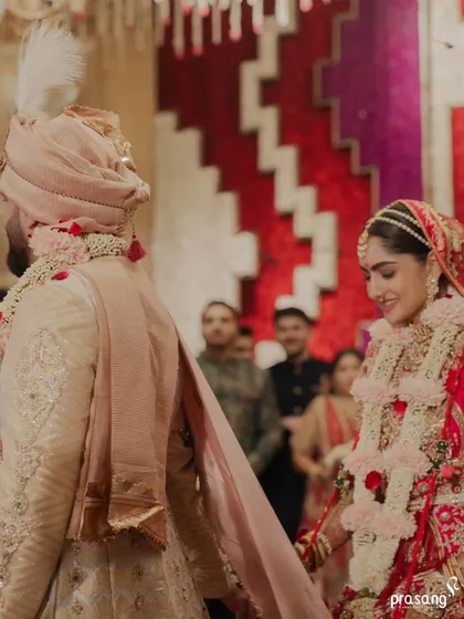 A candid shot of the couple during the pheras. The bride's smile as she follows the groom shows the happiness and trust that are at the heart of the celebration I help create.