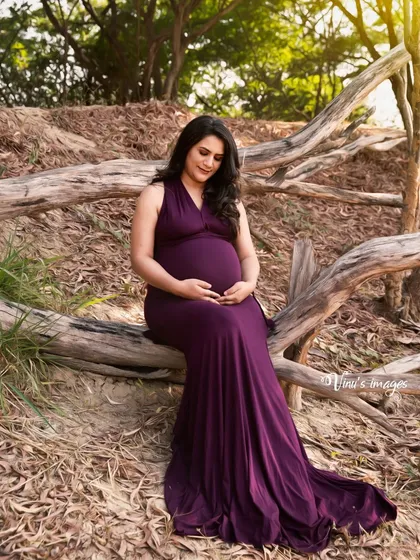 A duplicate image of 168, showing a serene moment of the mother-to-be cradling her bump in a beautiful woodland setting.