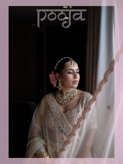 A beautiful, soft-lit portrait of the bride by a window, her expression serene and thoughtful.