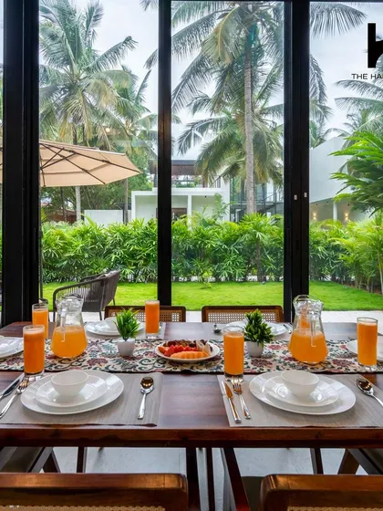 The dining area is set against a wall of glass, making every meal feel like an al fresco experience. This design choice is perfect for hospitality settings, offering guests a constant connection to the beautiful outdoors.