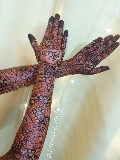 A crossed-hands pose showing the back of one hand and the front of the other, highlighting the different personalized elements.