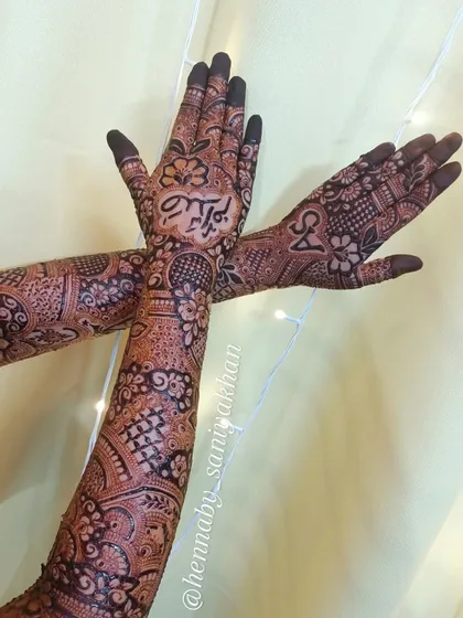 A crossed-hands pose showing the back of one hand and the front of the other, highlighting the different personalized elements.