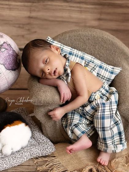 Even in his sleep, this little guy is a natural poser. The relaxed posture and adorable outfit make this shot a favorite.