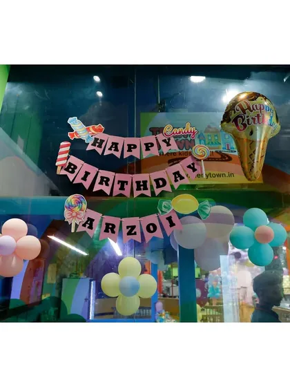 A fun 'Happy Birthday' banner for Arzoi's Candyland party.
