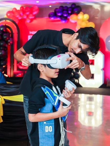 Our staff ensures every child has a safe and fun time with all our activities, including getting set up for a virtual reality adventure.