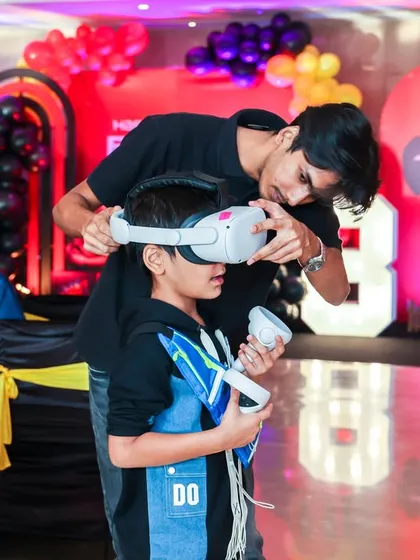 Our staff ensures every child has a safe and fun time with all our activities, including getting set up for a virtual reality adventure.