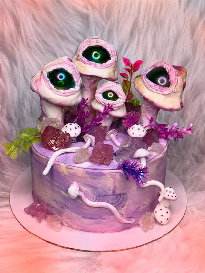 I love creepy and bizarre requests. This cake features surreal, eye-watching mushrooms on a purple marbled base, decorated with edible crystals. It's wonderfully weird.