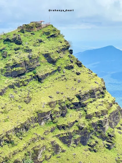 Another perspective of the Deviramma Betta peak, showing the small temple structure at the very top.