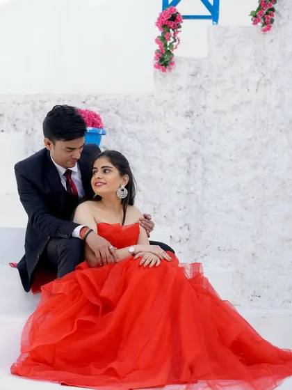 A sweet and romantic pre-wedding photo. The couple shares a quiet moment together on the steps, lost in their own world.