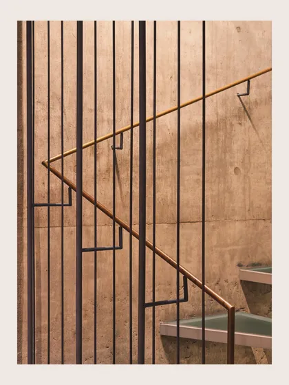 A detail of the staircase within the Jenga House. This image shows the precise combination of materials, with thin steel balusters set against a board-formed concrete wall, reflecting my focus on craftsmanship and material texture.
