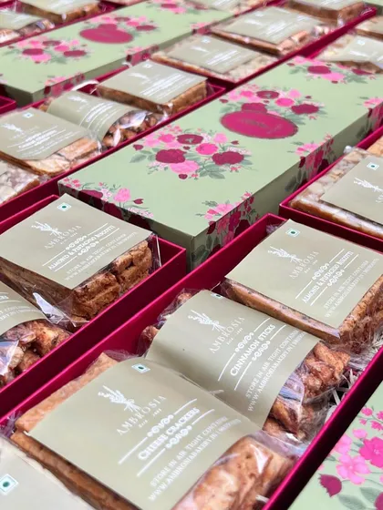 A closer look at the contents of our bulk gift hampers, showing the individually wrapped cheese crackers and almond biscotti.