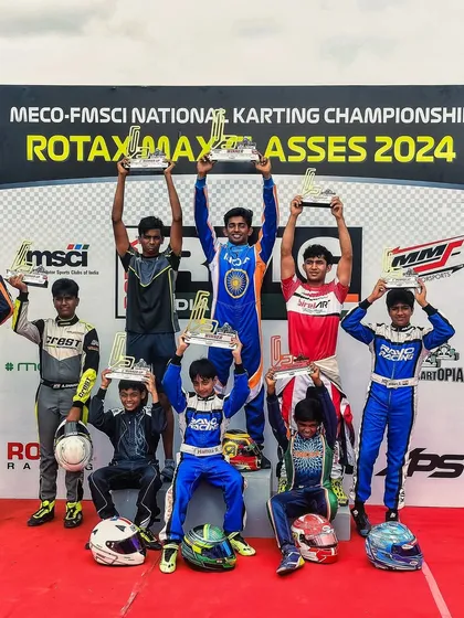 A group of champions from all classes celebrating on the podium after Round 2 of the 2024 National Karting Championship.