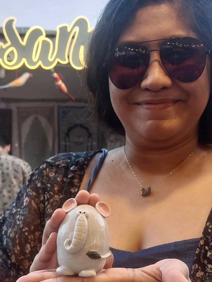 Me holding a small elephant figurine at The Lil Flea market in Mumbai. These little pieces are inspired by my mother's collection and carry a lot of sentimental value for me.