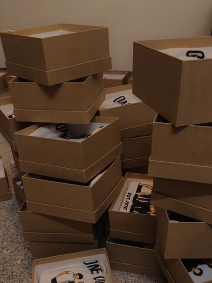 The behind-the-scenes of a bulk order for our One Direction hampers. Stacks of boxes ready to be filled and shipped to fans.