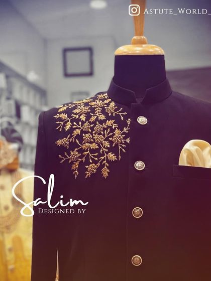 A close-up of the gold floral embroidery on the black Jodhpuri jacket. The detail shows the quality of the handwork that goes into each custom piece.