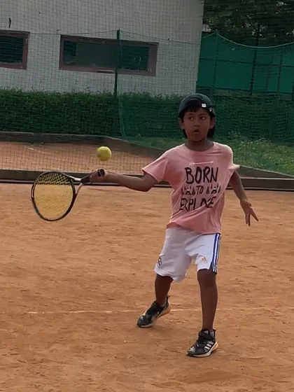 A great action shot of Kevlin Khatana hitting a forehand during a practice session.