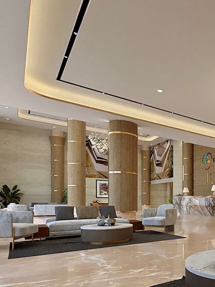 This perspective of the Voraskyline Icon lobby showcases the sense of scale and light. The curved seating arrangement and soft, ambient lighting create a comfortable and sophisticated waiting area.