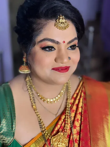 For her daughter's naming ceremony, this client wanted glittery eyes, and I was happy to deliver. I created a warm, glittery eye look with a classic red lip, which looked beautiful with her traditional silk saree and gold jewellery.