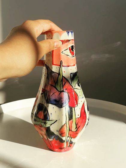 The finished hand-painted vase, showing how the underglaze colors transformed after firing.