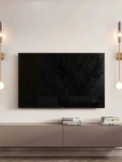 A pair of elegant wall sconces flanking a TV. This is a great way to add ambient lighting to your media area without causing glare on the screen.